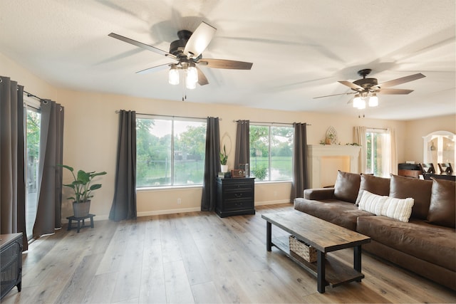 living room featuring light hardwood / wood-style floors and ceiling fan