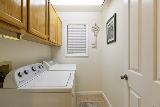 laundry area with cabinets, separate washer and dryer, and light tile patterned floors