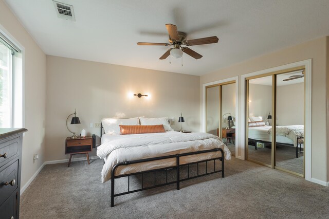 3182 Island Dr, Redding, CA 96001 - bedroom featuring two closets, light colored carpet, and ceiling fan