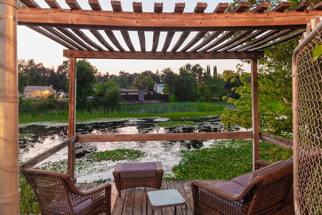 view of patio featuring a pergola and a water view