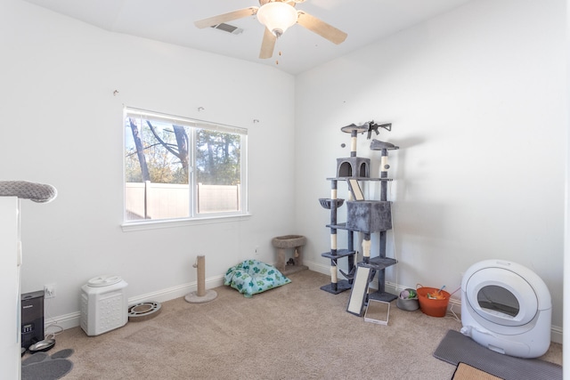 workout area featuring light carpet and ceiling fan