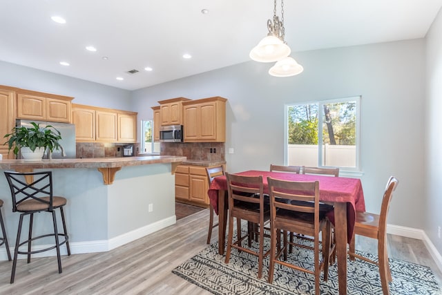 dining space with light wood-type flooring