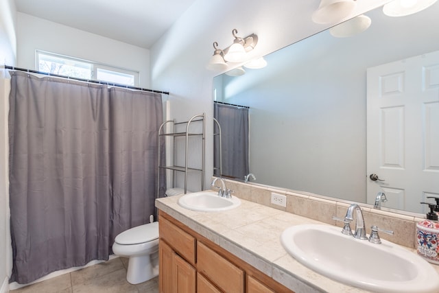 bathroom featuring vanity, tile patterned floors, and toilet