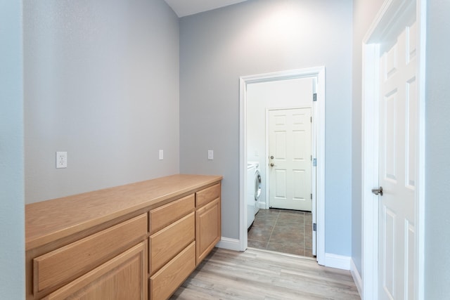 interior space featuring hardwood / wood-style flooring and washer and dryer