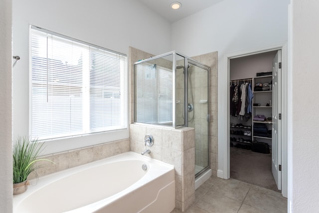 bathroom with a healthy amount of sunlight, tile patterned floors, and plus walk in shower