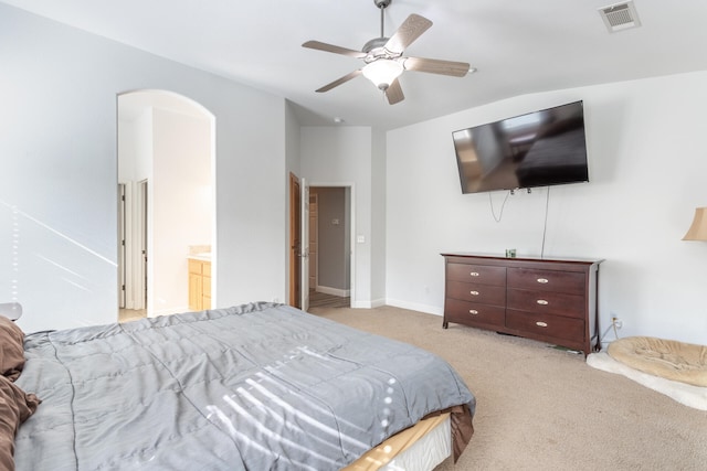 carpeted bedroom featuring vaulted ceiling, ceiling fan, and ensuite bathroom