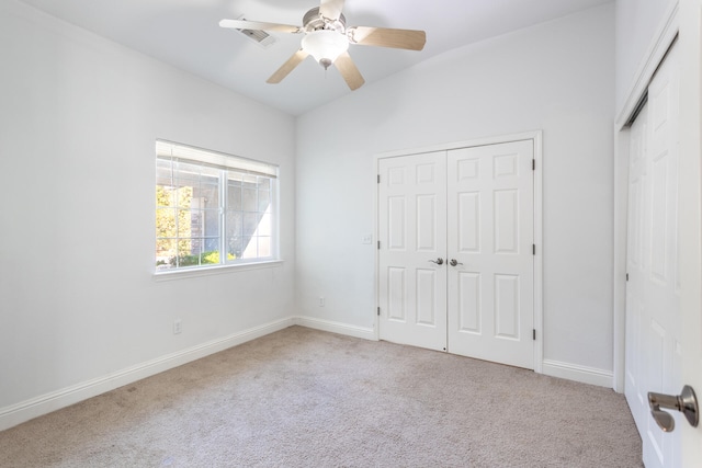 unfurnished bedroom with light colored carpet and ceiling fan