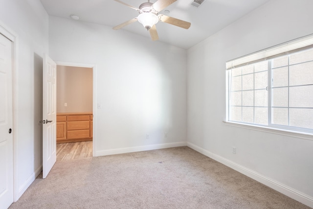 spare room with light carpet and ceiling fan