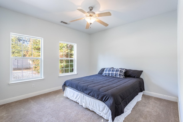 carpeted bedroom with ceiling fan