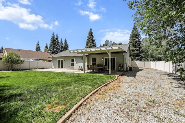 rear view of house with a pergola, a fenced backyard, a yard, stucco siding, and a patio area