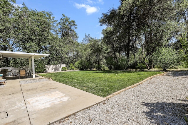 view of yard with fence and a patio area