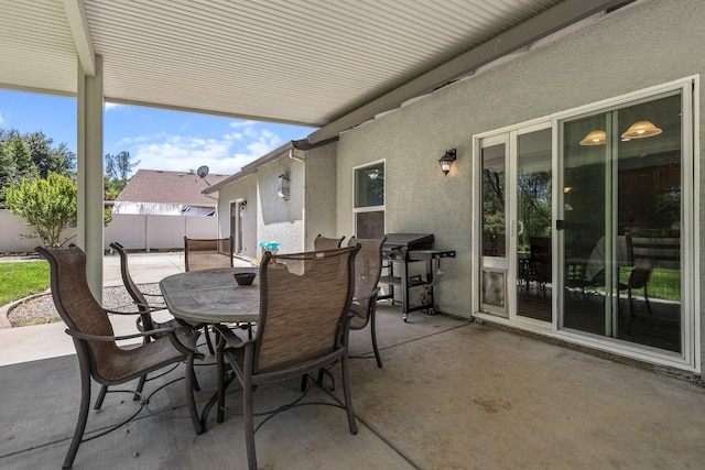 view of patio with outdoor dining space, area for grilling, and a fenced backyard