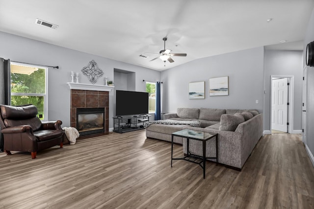living area featuring wood finished floors, visible vents, and plenty of natural light