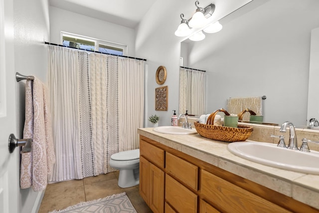 full bathroom featuring toilet, tile patterned floors, a sink, and double vanity