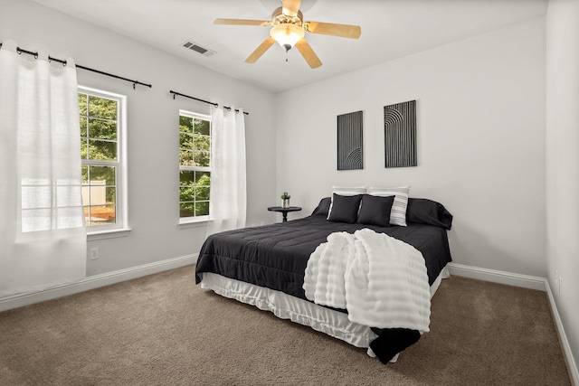 bedroom with carpet floors, visible vents, and baseboards