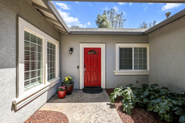 property entrance with stucco siding