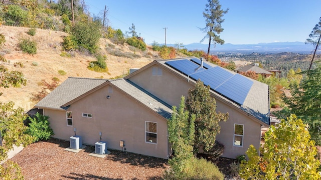 exterior space with solar panels and a mountain view