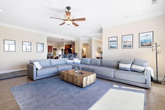 tiled living room featuring ceiling fan and crown molding