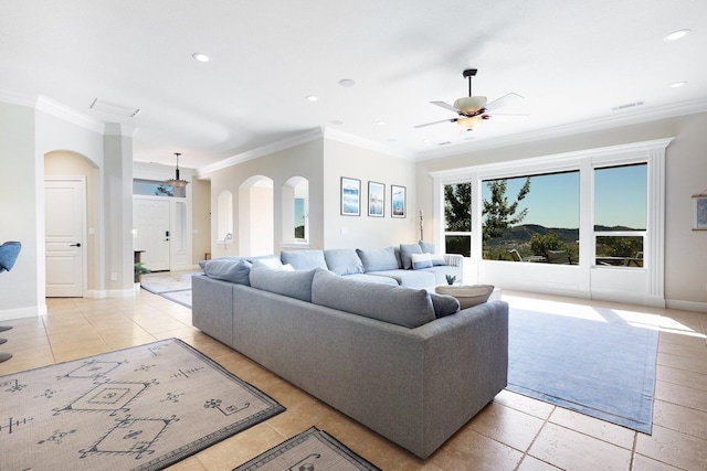 living room with light tile patterned floors, ceiling fan, and ornamental molding