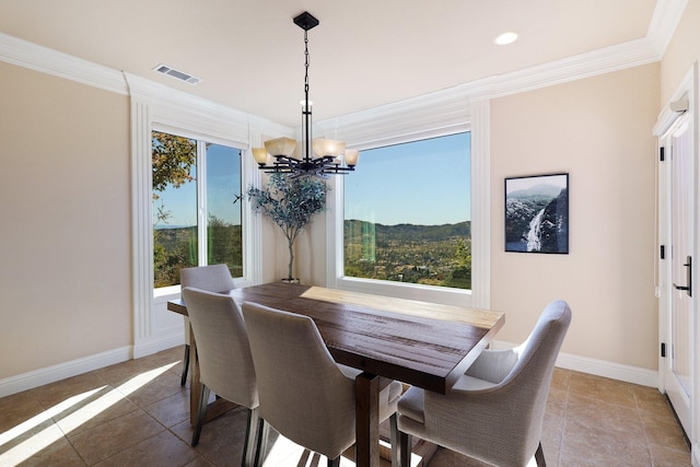 tiled dining room featuring a notable chandelier, a healthy amount of sunlight, a mountain view, and ornamental molding