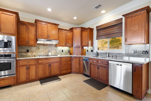 kitchen with decorative backsplash, crown molding, and stainless steel appliances