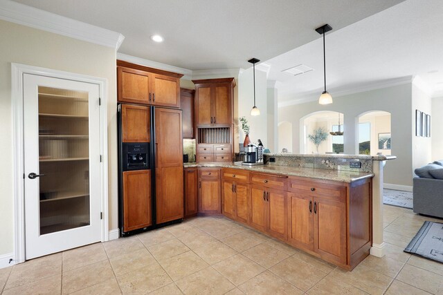 kitchen featuring decorative light fixtures, paneled refrigerator, kitchen peninsula, and ornamental molding