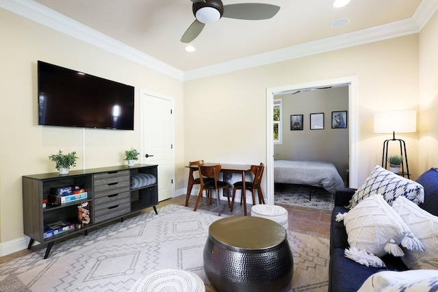 living room with ceiling fan and ornamental molding