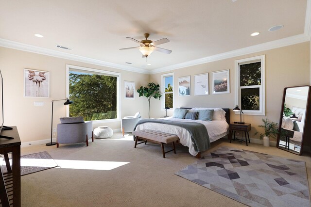 carpeted bedroom with ceiling fan and crown molding