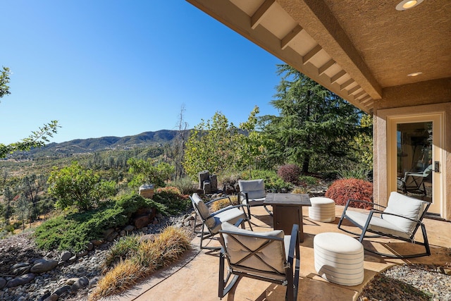 view of patio / terrace featuring a mountain view