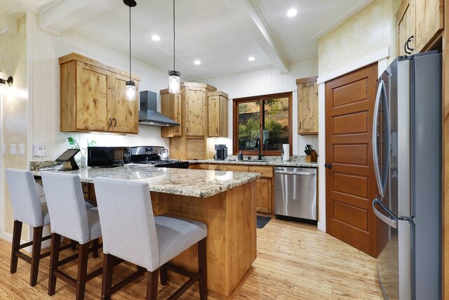 kitchen featuring wall chimney range hood, light hardwood / wood-style flooring, beamed ceiling, kitchen peninsula, and black appliances