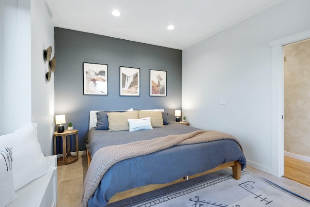 bedroom with light hardwood / wood-style floors and crown molding