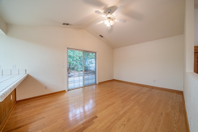 unfurnished living room featuring light hardwood / wood-style flooring, ceiling fan, and lofted ceiling