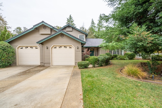 view of front of home with a front yard and a garage