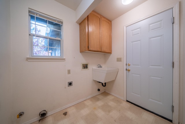 washroom featuring electric dryer hookup, cabinets, hookup for a gas dryer, sink, and washer hookup