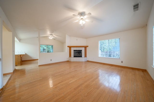 unfurnished living room with a fireplace, light hardwood / wood-style flooring, ceiling fan, and lofted ceiling