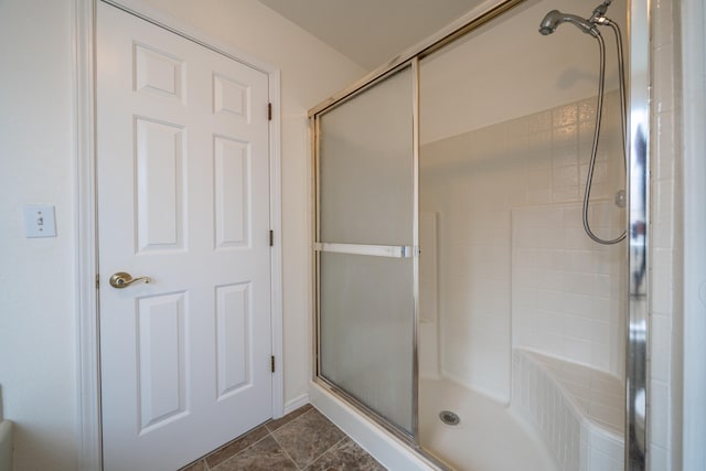 bathroom with tile patterned floors and a shower with shower door