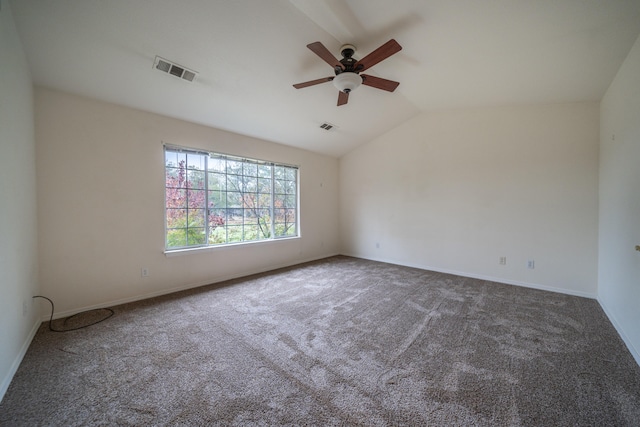 carpeted empty room featuring vaulted ceiling and ceiling fan