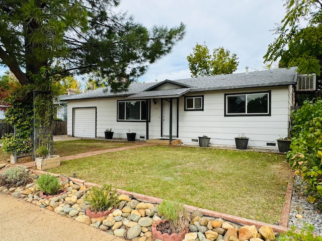 single story home with a front yard and a garage