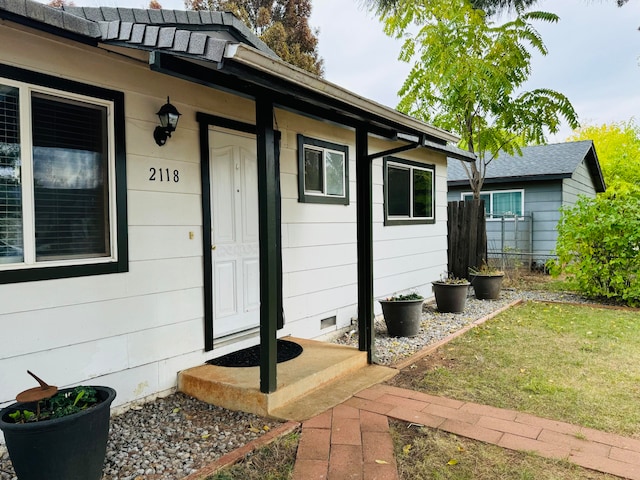 doorway to property featuring a lawn