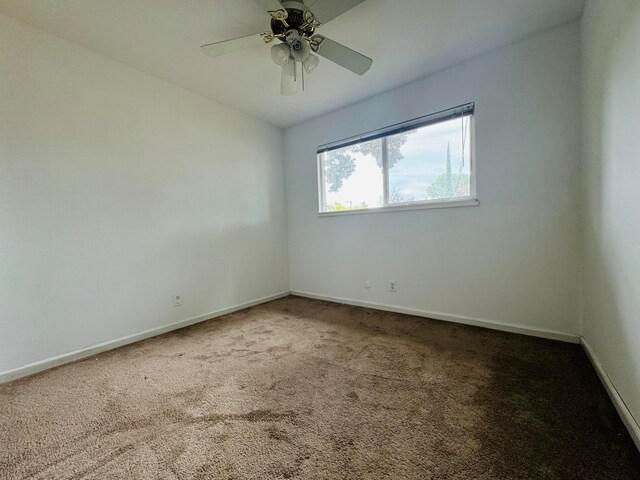 empty room with carpet flooring and ceiling fan