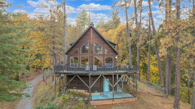 rear view of house featuring a wooden deck