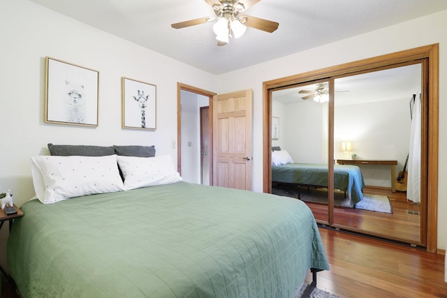 bedroom with wood-type flooring, a closet, and ceiling fan