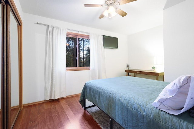 bedroom with hardwood / wood-style flooring and ceiling fan