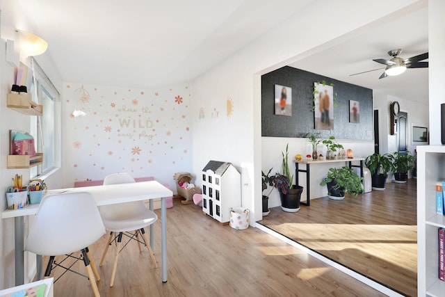 recreation room with ceiling fan and wood-type flooring