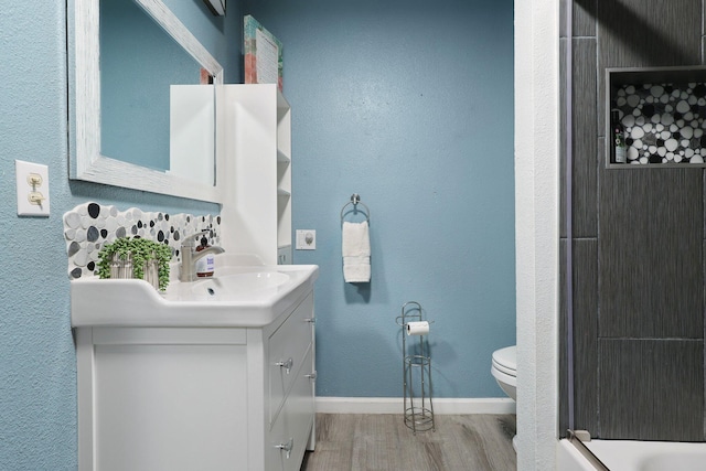 bathroom featuring hardwood / wood-style floors, vanity, and toilet