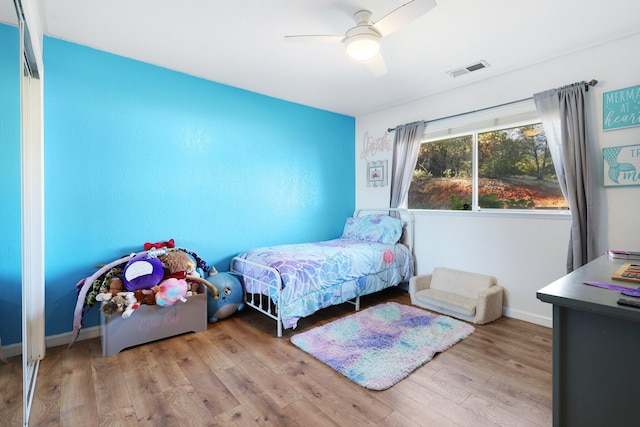 bedroom with light wood-type flooring and ceiling fan