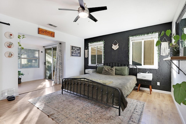 bedroom with ceiling fan and light hardwood / wood-style floors