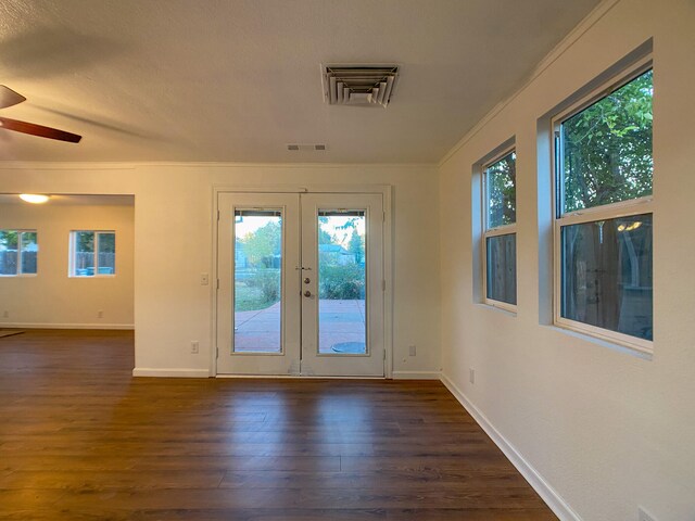 entryway featuring dark hardwood / wood-style flooring, ceiling fan, crown molding, and french doors