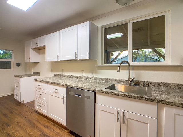 kitchen featuring dark wood-type flooring, white cabinetry, stainless steel dishwasher, and sink