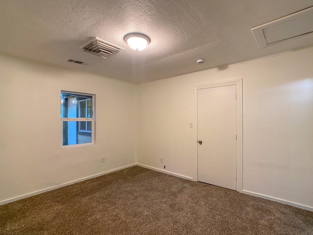 carpeted empty room with a textured ceiling